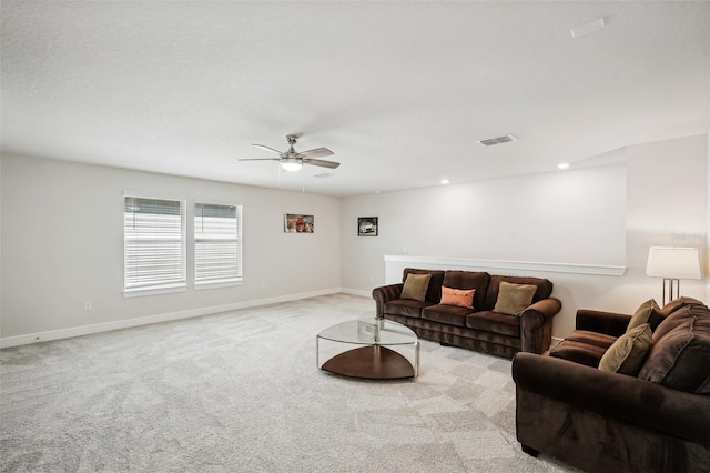 carpeted living room featuring ceiling fan