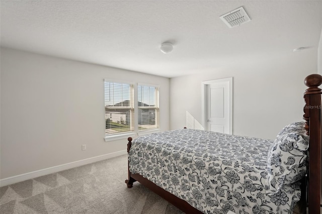 carpeted bedroom featuring a textured ceiling