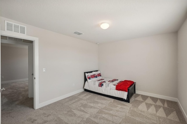 bedroom featuring light colored carpet