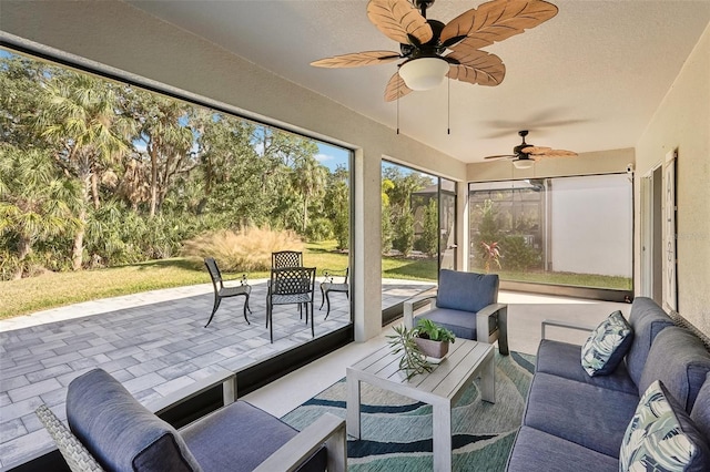 sunroom featuring ceiling fan