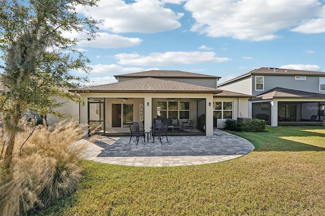 back of house featuring a yard, a patio, and ceiling fan