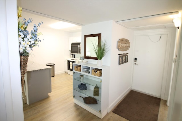 hallway with light hardwood / wood-style flooring