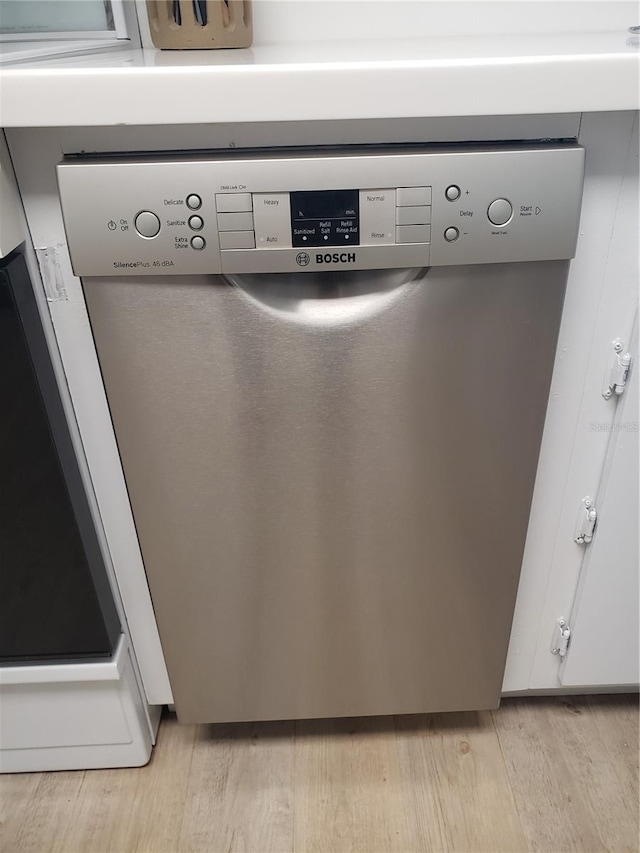 room details featuring dishwasher and light wood-type flooring