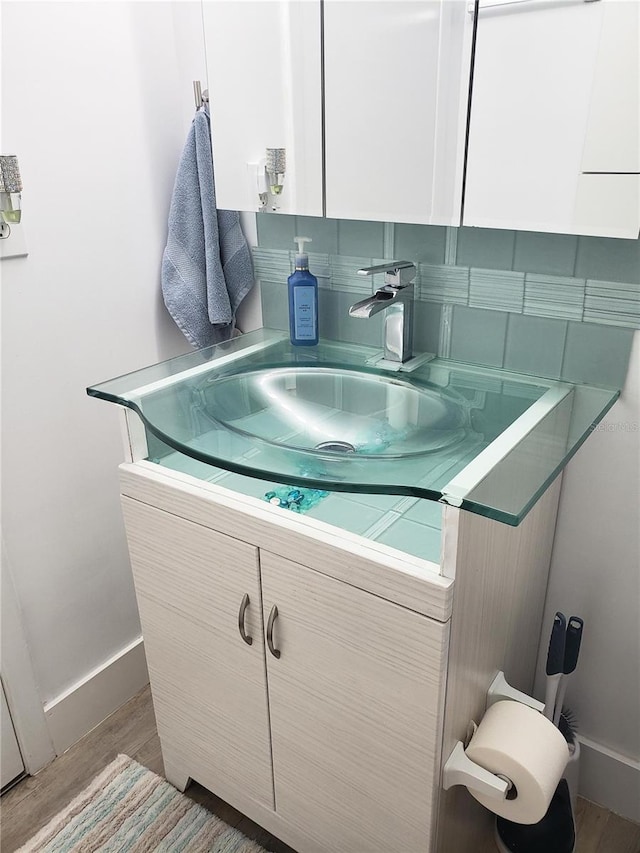 bathroom featuring hardwood / wood-style flooring and vanity