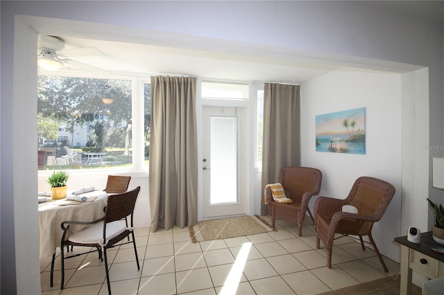 tiled foyer featuring ceiling fan