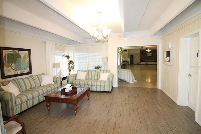 living room featuring wood-type flooring and a chandelier