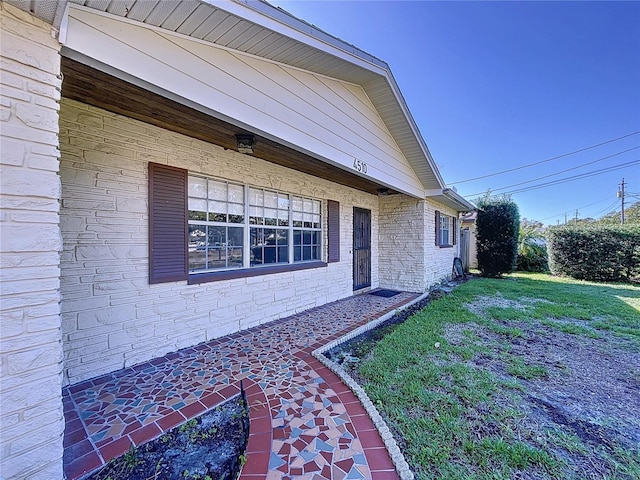 view of side of property with a lawn