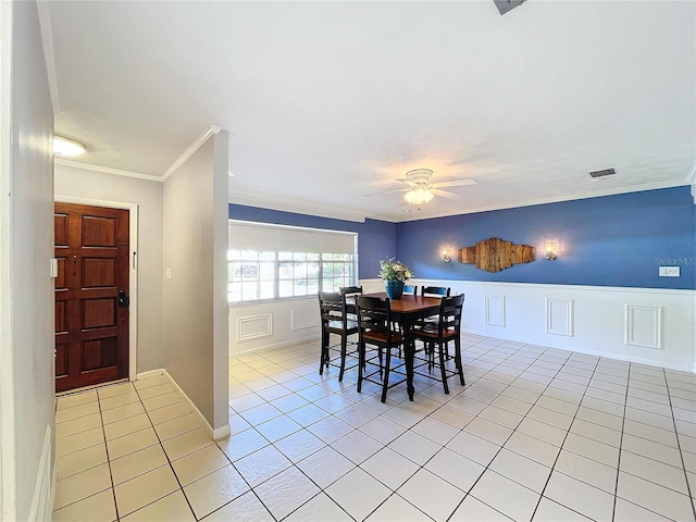 dining room featuring ceiling fan, crown molding, and light tile patterned floors