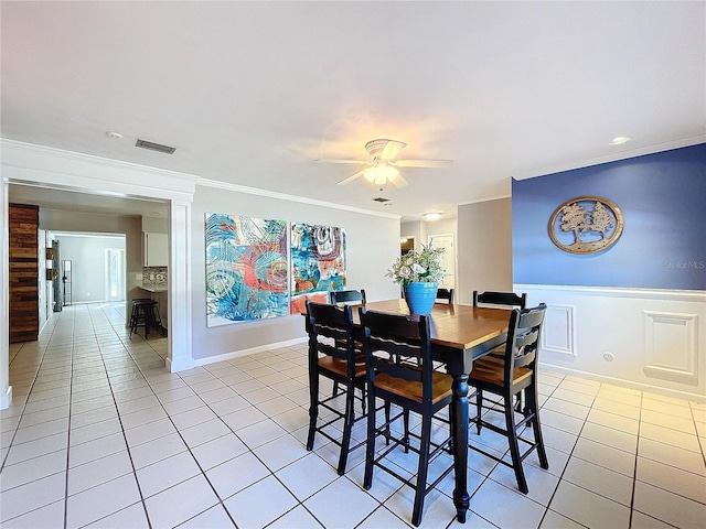 dining room featuring light tile patterned floors, ceiling fan, and ornamental molding