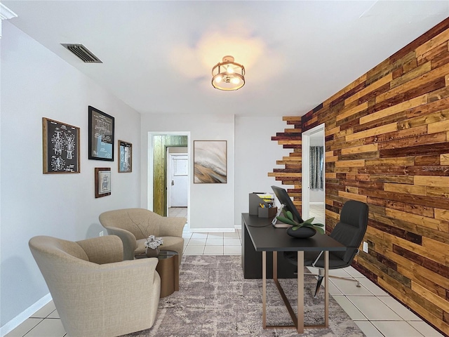 home office featuring light tile patterned floors and wood walls