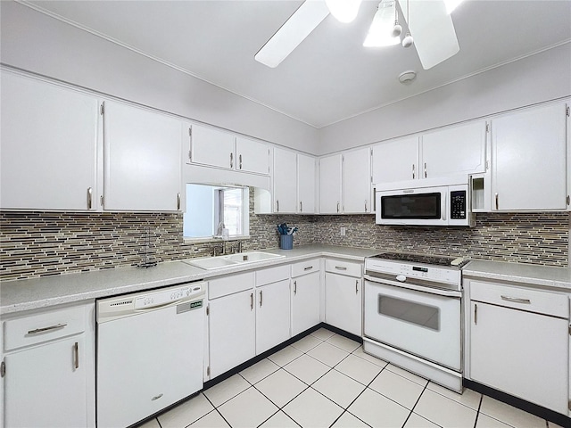 kitchen with ceiling fan, sink, tasteful backsplash, white appliances, and white cabinets