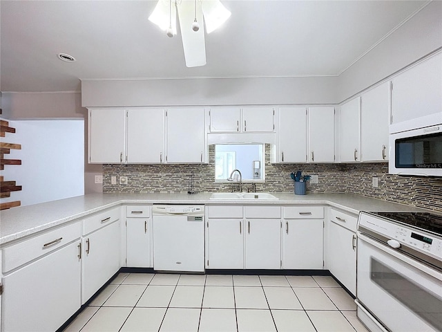 kitchen featuring white cabinetry, sink, backsplash, white appliances, and light tile patterned flooring