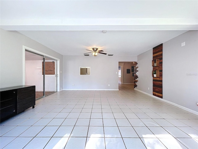 unfurnished living room featuring ceiling fan, plenty of natural light, and light tile patterned flooring