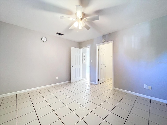 unfurnished room with ceiling fan and light tile patterned floors