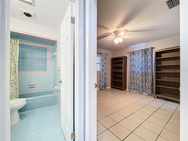 bathroom featuring tile patterned floors, ceiling fan, toilet, and shower / tub combo with curtain