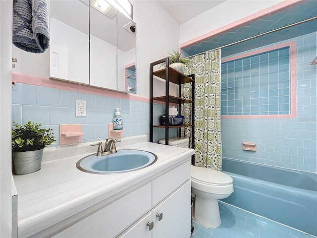 full bathroom with shower / tub combo, tile patterned floors, toilet, vanity, and tile walls