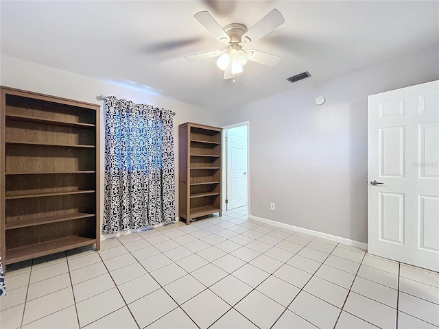 spare room with light tile patterned floors and ceiling fan