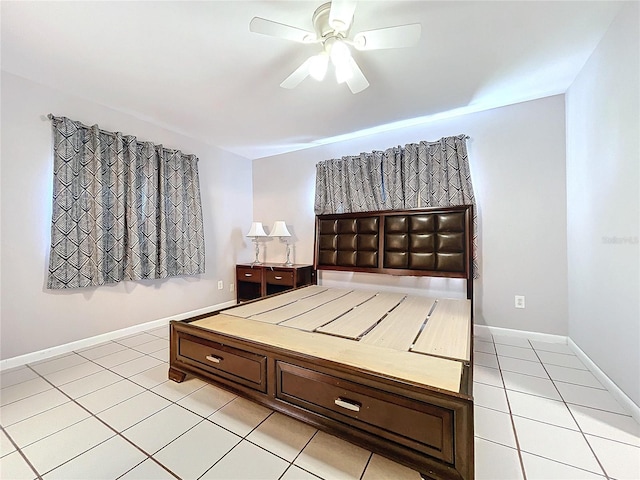 unfurnished bedroom featuring light tile patterned floors and ceiling fan