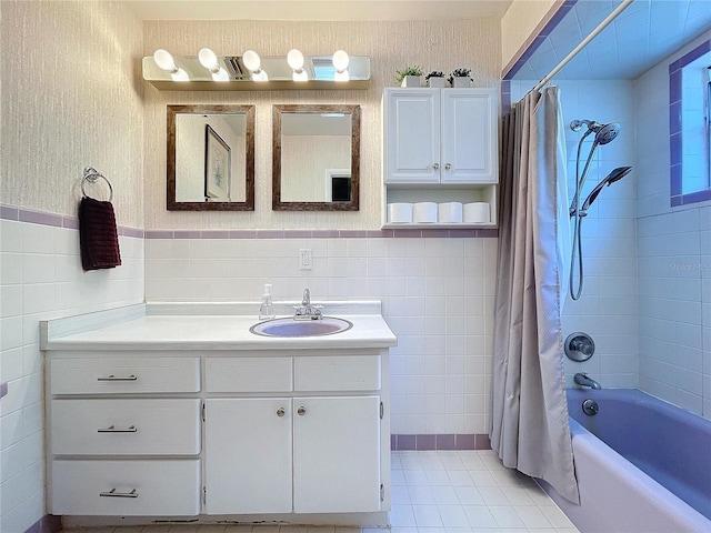 bathroom featuring tile patterned flooring, vanity, tile walls, and shower / tub combo