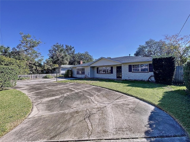 ranch-style home with a front lawn