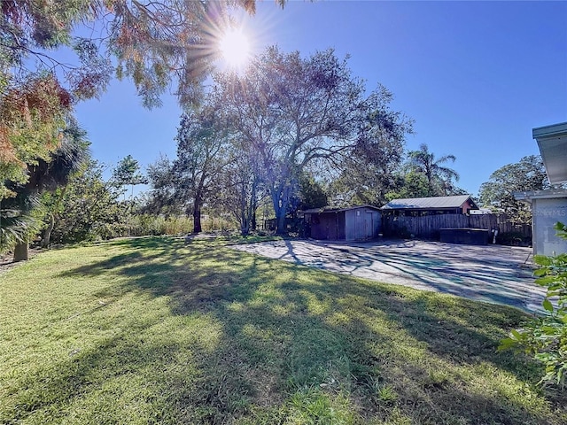 view of yard featuring a patio and a shed