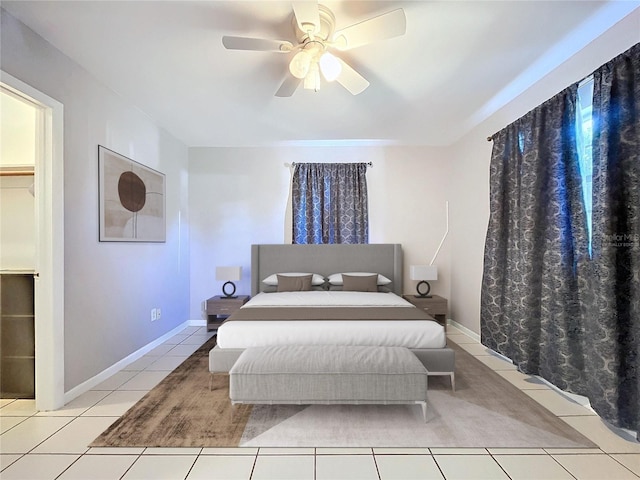 bedroom with a walk in closet, ceiling fan, and light tile patterned flooring