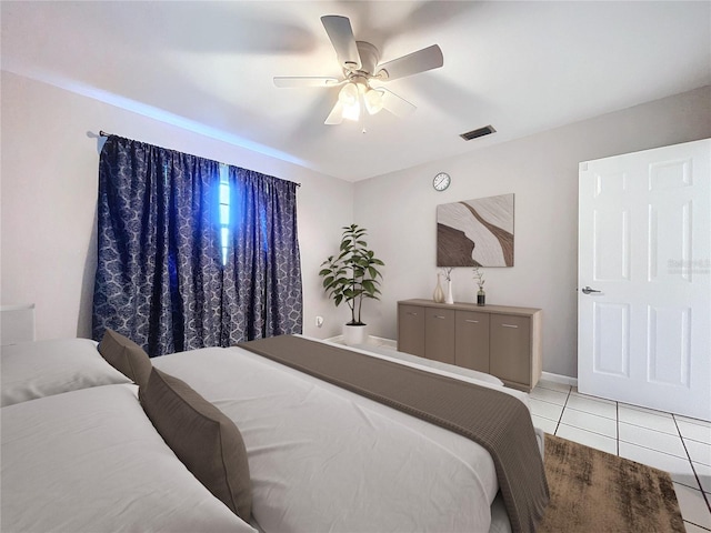 tiled bedroom with ceiling fan