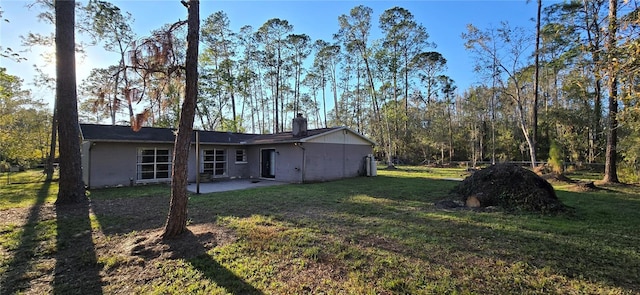 back of house featuring a yard and a patio area