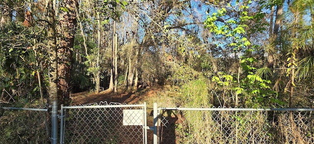 view of yard with fence and a forest view