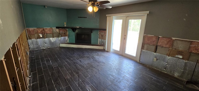 6906 Quail Hollow Blvd, Wesley Chapel, FL 33544 - unfurnished living room with french doors, plenty of natural light, wood finished floors, and a fireplace with raised hearth