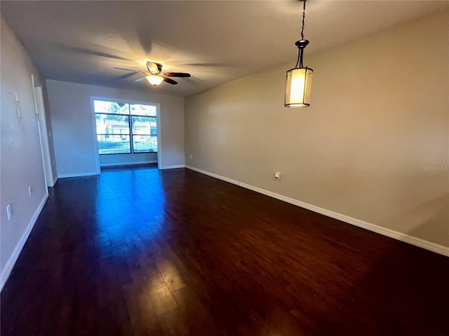 spare room with ceiling fan and dark hardwood / wood-style floors