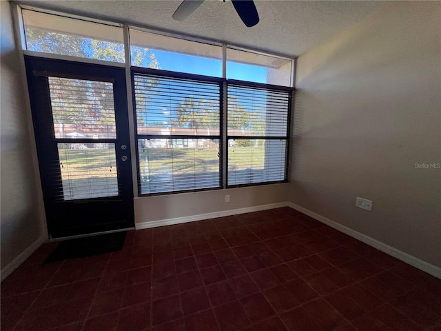 spare room featuring a textured ceiling and ceiling fan