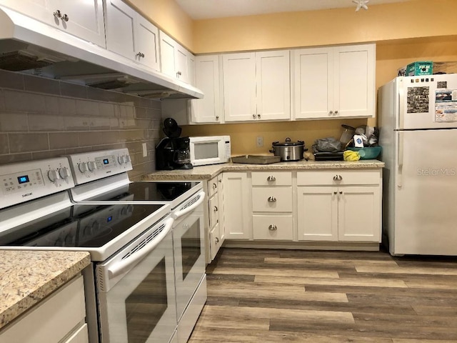 kitchen featuring white cabinets, light hardwood / wood-style floors, and white appliances