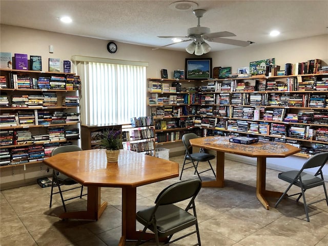 dining room featuring ceiling fan and a textured ceiling