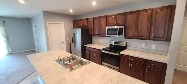 kitchen with sink, light tile patterned floors, and stainless steel appliances