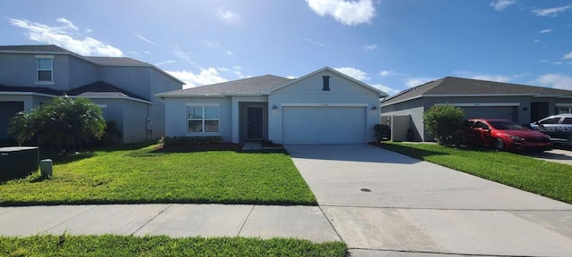 view of front of home with a garage and a front yard