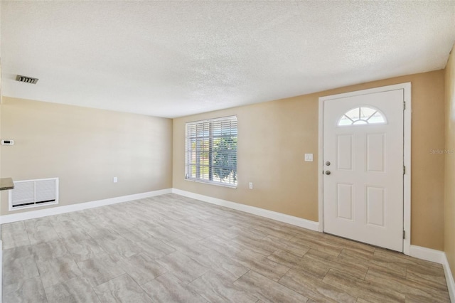 entrance foyer featuring plenty of natural light and a textured ceiling