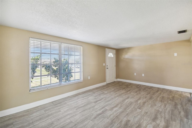 empty room featuring a textured ceiling