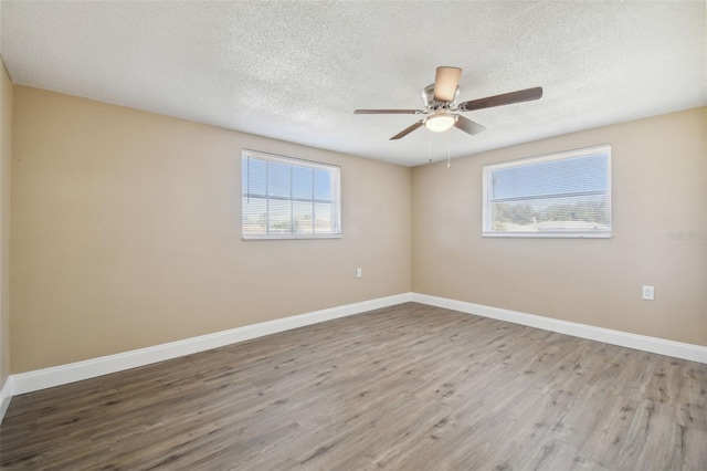 unfurnished room with hardwood / wood-style floors, a textured ceiling, and ceiling fan