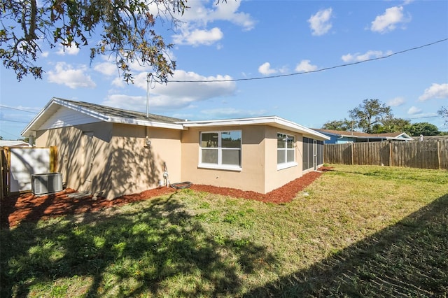 view of side of home featuring a lawn and central air condition unit