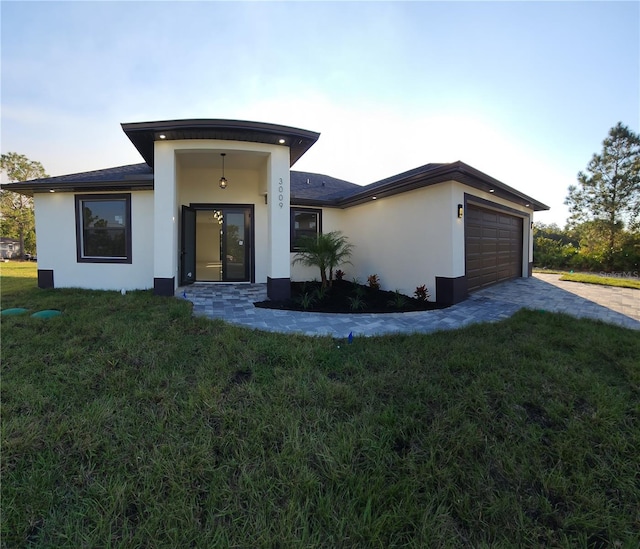 view of front of home featuring a garage and a front lawn