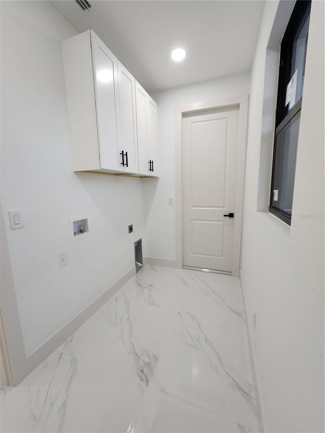 laundry area with hookup for an electric dryer, cabinets, and hookup for a washing machine