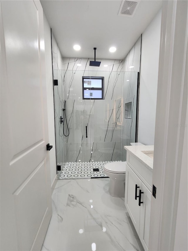 bathroom with vanity, toilet, and a shower with door