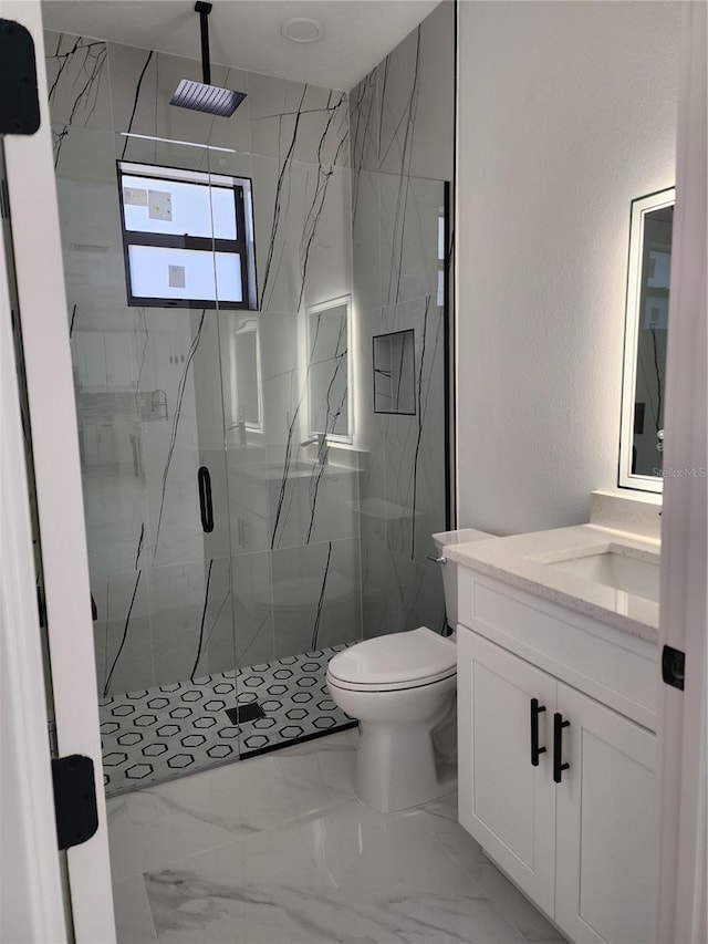 bathroom featuring vanity, toilet, and walk in shower