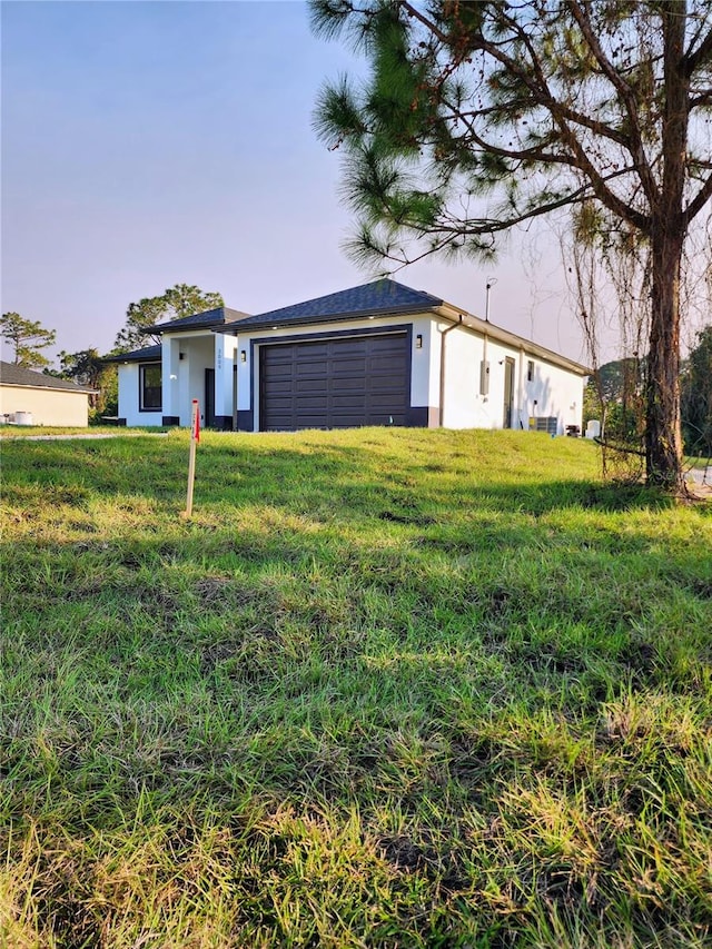 view of front of property with a lawn and a garage