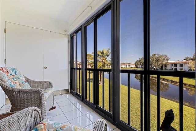 sunroom / solarium with a water view