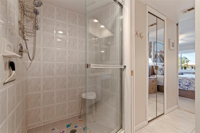 bathroom featuring tile patterned flooring and a shower with shower door