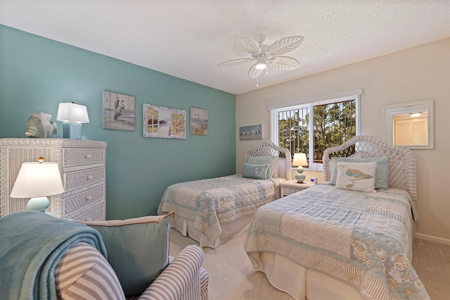 carpeted bedroom featuring ceiling fan and a textured ceiling