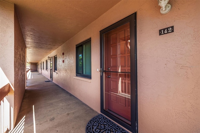 view of exterior entry with stucco siding