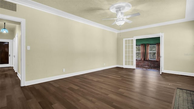 spare room with french doors, dark hardwood / wood-style flooring, ceiling fan, and crown molding